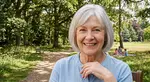 Profile photo of Maria G., a cheerful elderly woman with silver hair wearing a light blue blouse